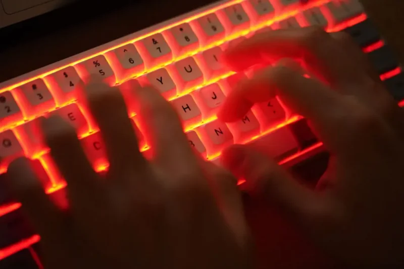 BERLIN, GERMANY - JANUARY 25: In this photo illustration a young man types on an illuminated computer keyboard typically favored by computer coders on January 25, 2021 in Berlin, Germany. (Photo by Sean Gallup/Getty Images)