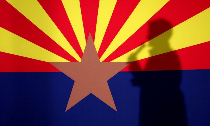 PRESCOTT, AZ - NOVEMBER 07: The shadow of Arizona Republican gubernatorial candidate Kari Lake is cast onto the Arizona state flag as she speaks during a get out the vote campaign rally on November 07, 2022 in Prescott, Arizona. With 1 days to go until election day, Kari Lake and other Republican candidates campaigning throughout the state ahead of Tuesday's midterm election. (Photo by Justin Sullivan/Getty Images) (Photo by Justin Sullivan/Getty Images)