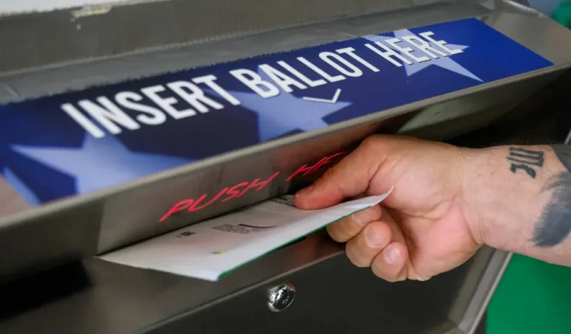 A voter uses a ballot drop box at the Bucks County Administration building voting on demand and ballot drop center in Doylestown, Pennsylvania, on October 31, 2024. (Photo by Ed JONES / AFP) (Photo by ED JONES/AFP via Getty Images)
