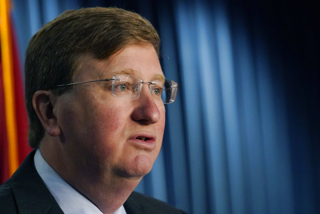 Mississippi Gov. Tate Reeves explains to reporters some of the line items that he vetoed from the appropriations allocated by the state Legislature, Thursday, April 28, 2022, in Jackson, Miss. (AP Photo/Rogelio V. Solis)