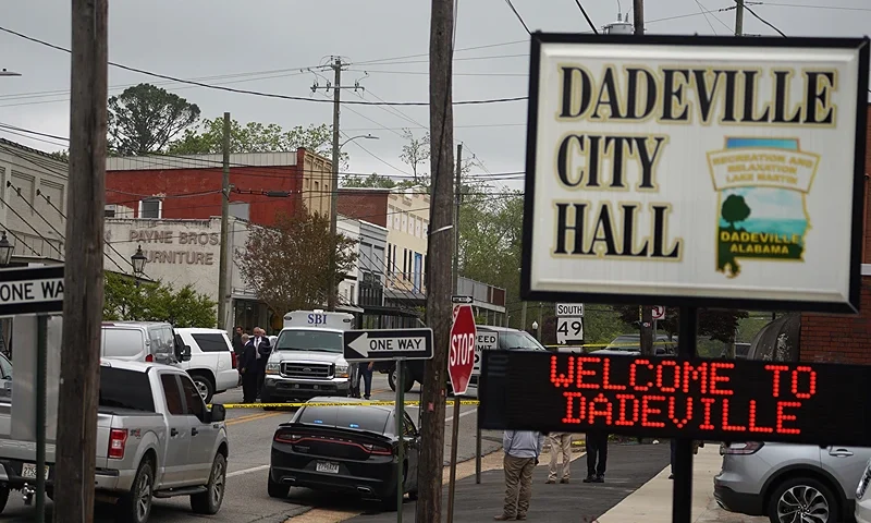 DADEVILLE, AL - APRIL 16: Community members watch as crime scene investigators work the scene of a shooting on April 16, 2023 in Dadeville, Alabama. According to reports, at least four people were killed and others injured in a shooting during a birthday party at a dance studio on Saturday night. (Photo by Megan Varner/Getty Images)