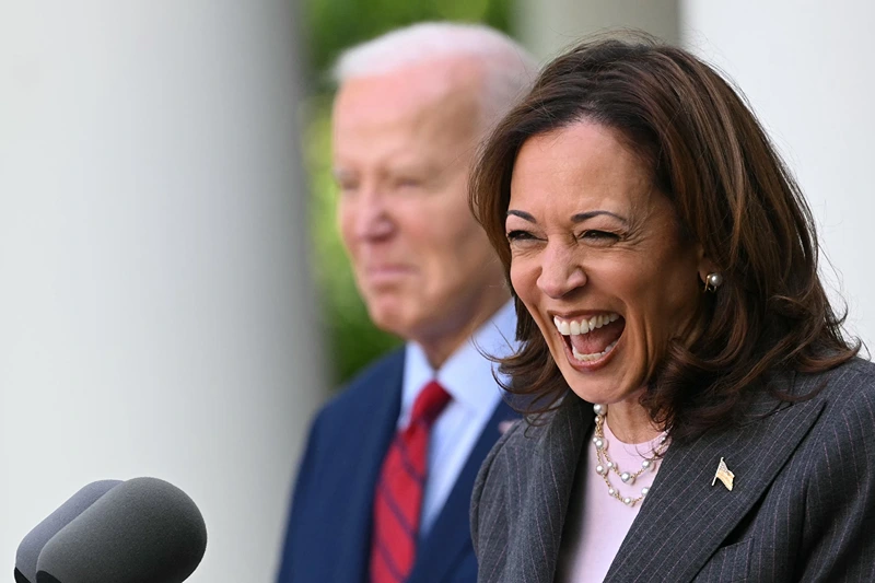 US President Joe Biden listens as Vice President Kamala Harris delivers remarks at a reception celebrating Asian American, Native Hawaiian, and Pacific Islander Heritage Month in the Rose Garden of the White House in Washington, DC on May 13, 2024. (Photo by Mandel NGAN / AFP) (Photo by MANDEL NGAN/AFP via Getty Images)